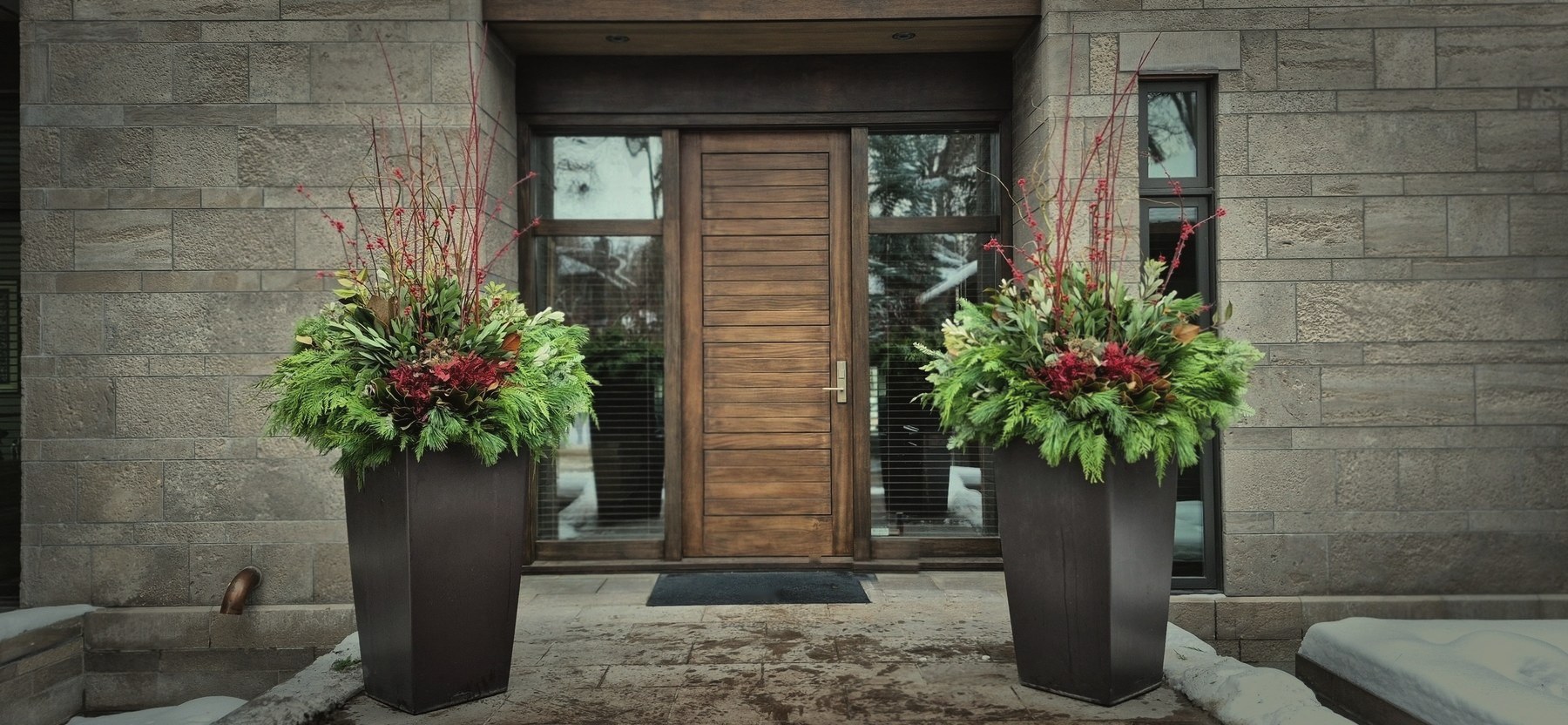 Winter planters at a modern entrance